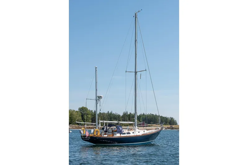 Slide: The Image of 1971 Hinckley Bermuda 40 Custom Yawl sailing on calm waters under clear blue sky. - 16