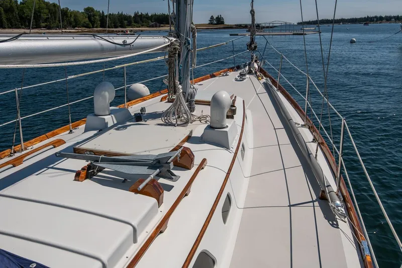 Slide: The Image of 1971 Hinckley Bermuda 40 Custom Yawl sailing on calm waters, showcasing elegant deck design. - 17