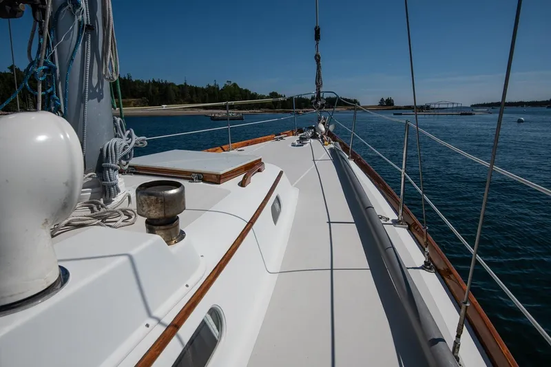 Slide: The Image of 1971 Hinckley Bermuda 40 Custom Yawl sailing on calm waters, clear sky. - 18