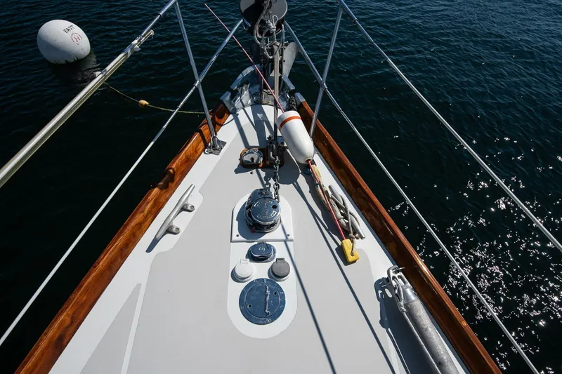 Slide: The Image of Hinckley Bermuda 40 Custom Yawl 1971 deck view with ropes and fittings on calm water. - 19