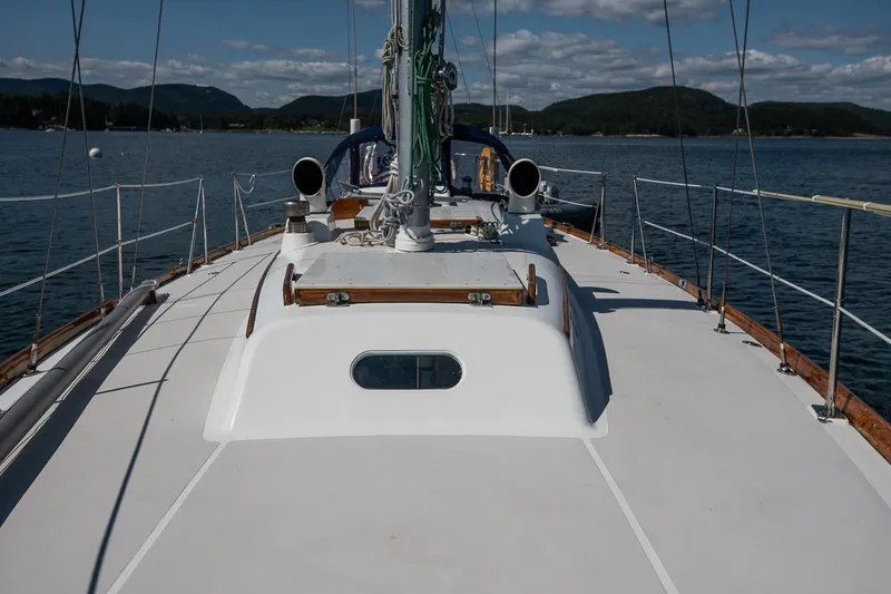 Slide: The Image of 1971 Hinckley Bermuda 40 Custom Yawl sailing on calm waters under a clear sky. - 20