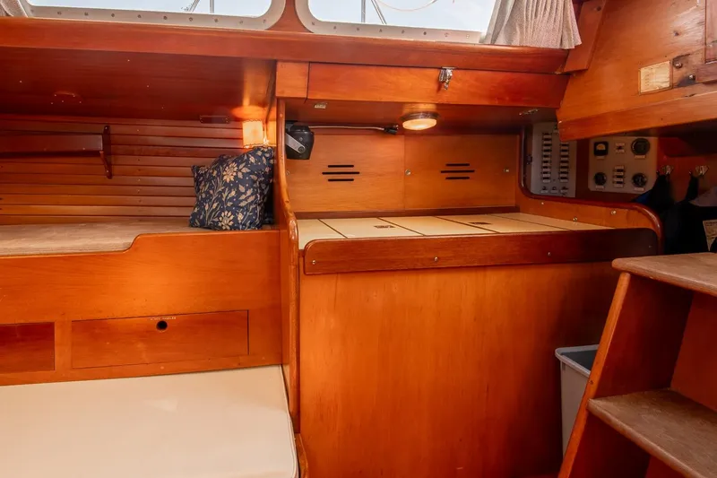 Slide: The Image of Interior of 1971 Hinckley Bermuda 40 Custom Yawl, featuring wooden cabinetry and seating. - 25
