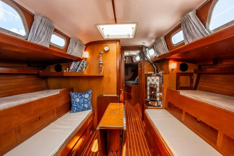 Slide: The Image of Interior of 1971 Hinckley Bermuda 40 Custom Yawl, featuring wooden finishes and cozy seating. - 27