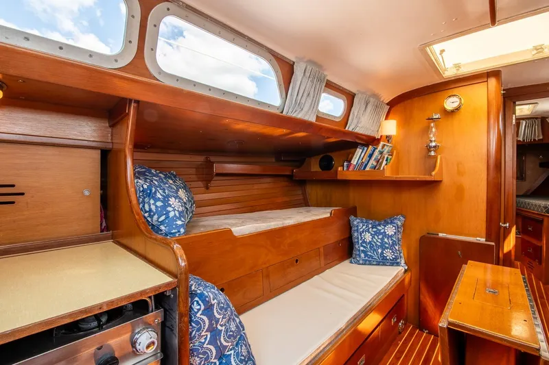 Slide: The Image of Interior of 1971 Hinckley Bermuda 40 Custom Yawl with wooden furnishings and cozy seating. - 28