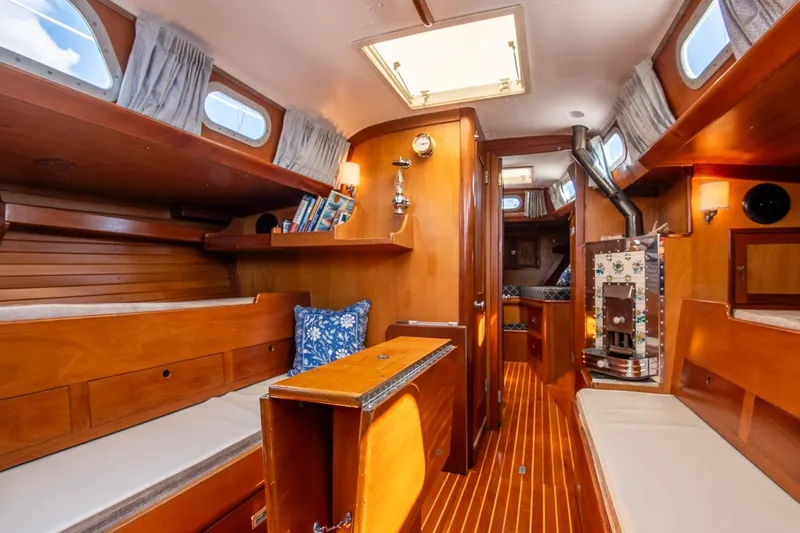 Slide: The Image of Interior of 1971 Hinckley Bermuda 40 Custom Yawl, featuring wooden finishes and cozy seating. - 29