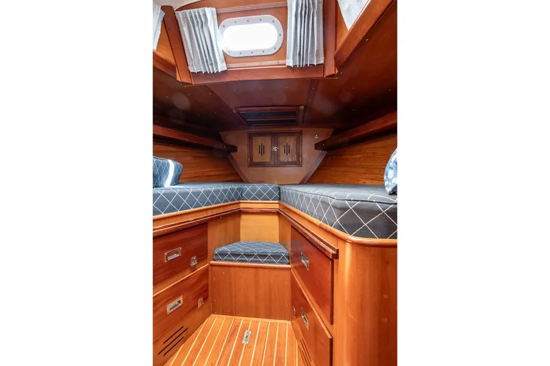 Slide: The Image of Hinckley Bermuda 40 Custom Yawl 1971 interior with wooden cabinetry and cushioned seating. - 34