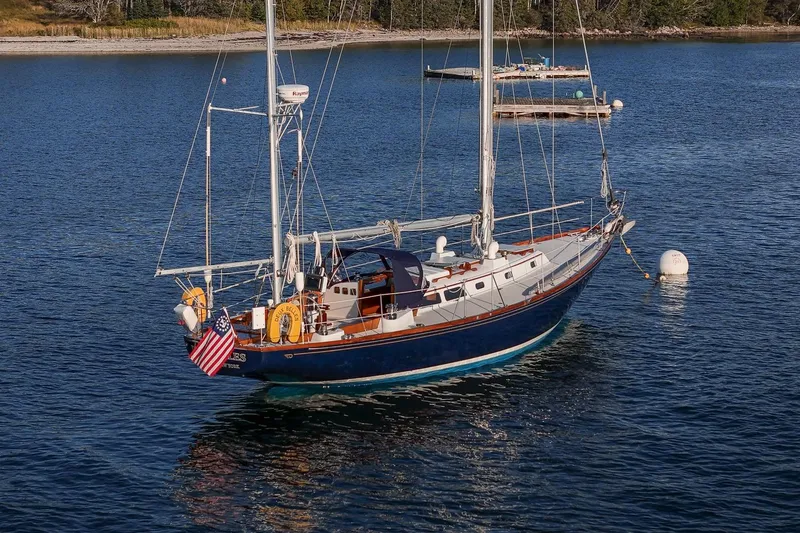 Slide: The Image of 1971 Hinckley Bermuda 40 Custom Yawl sailing on calm waters, displaying elegance and craftsmanship. - 9