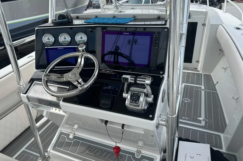 Slide: The Image of 1999 Jupiter 31 Cuddy boat helm with modern controls and navigation displays. - 2