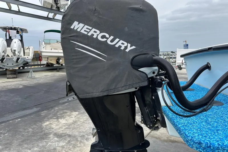 Slide: The Image of 1999 Jupiter 31 Cuddy with Mercury outboard motor, docked at marina. - 22