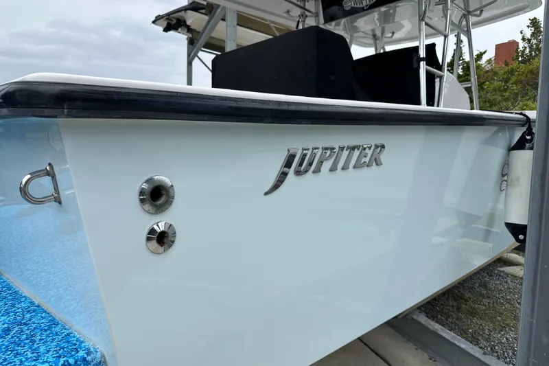 Slide: The Image of 1999 Jupiter 31 Cuddy boat, side view with logo and fittings. - 23