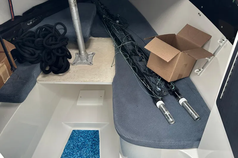 Slide: The Image of Interior of a 1999 Jupiter 31 Cuddy boat with ropes and equipment. - 27