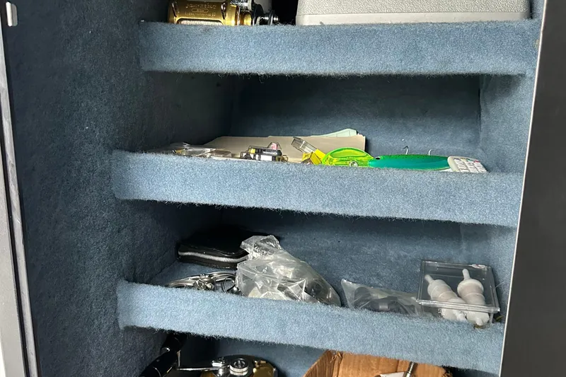 Slide: The Image of Interior of a storage compartment with fishing gear and miscellaneous items. - 29