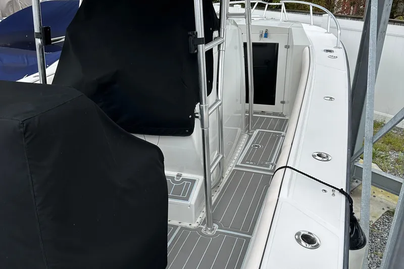 Slide: The Image of 1999 Jupiter 31 Cuddy boat interior with covered seating and sleek design. - 31