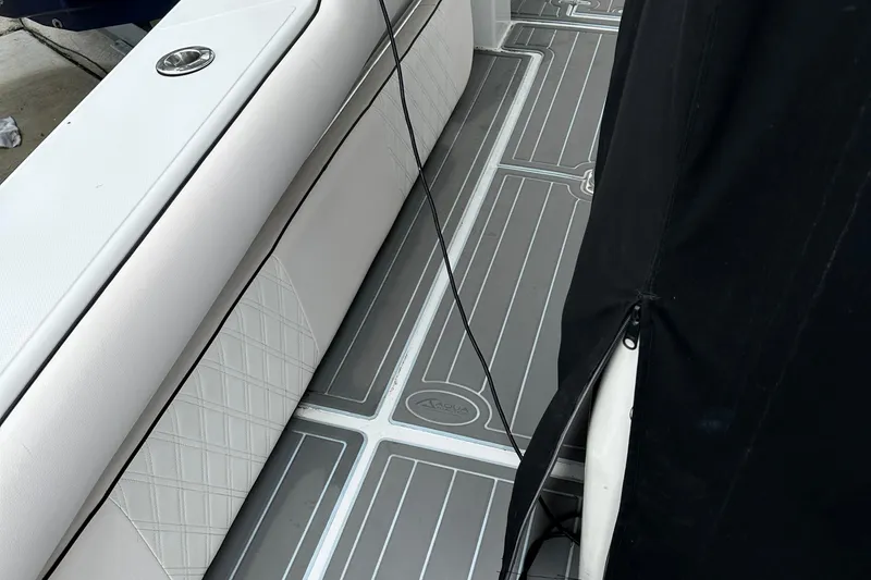 Slide: The Image of 1999 Jupiter 31 Cuddy boat interior with white seating and gray flooring. - 32