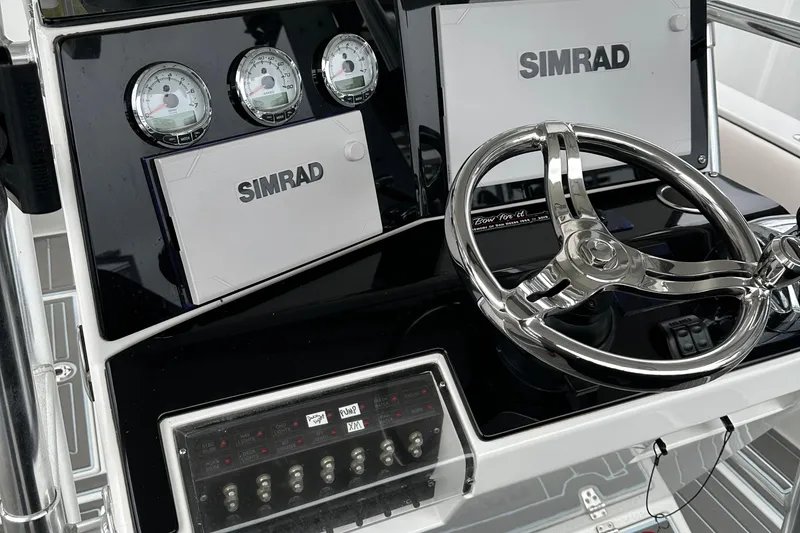 Slide: The Image of Control panel of a 1999 Jupiter 31 Cuddy boat with Simrad navigation system. - 33