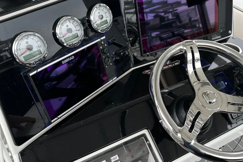 Slide: The Image of 1999 Jupiter 31 Cuddy boat dashboard with gauges and steering wheel. - 34