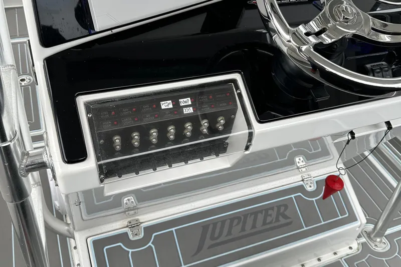 Slide: The Image of Control panel of a 1999 Jupiter 31 Cuddy boat with steering wheel. - 35