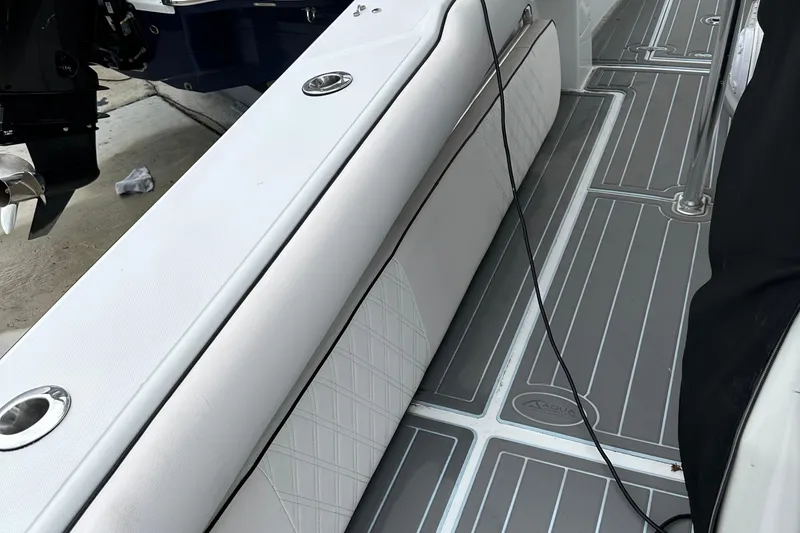 Slide: The Image of Interior view of a 1999 Jupiter 31 Cuddy boat with sleek seating and modern flooring. - 36