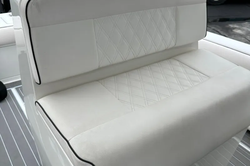 Slide: The Image of White cushioned seating on 1999 Jupiter 31 Cuddy boat with diamond stitching. - 39