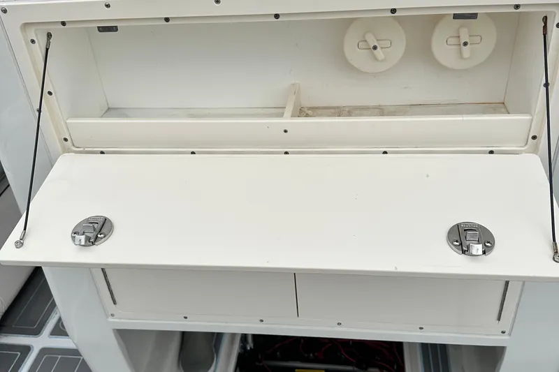 Slide: The Image of 1999 Jupiter 31 Cuddy boat storage compartment with open hatch and latches. - 41