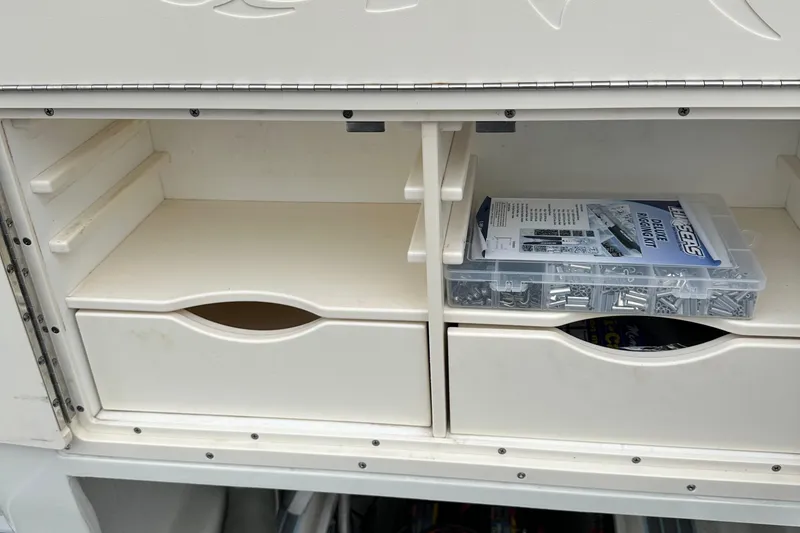 Slide: The Image of Storage compartment on a 1999 Jupiter 31 Cuddy boat with organized rigging kit. - 42
