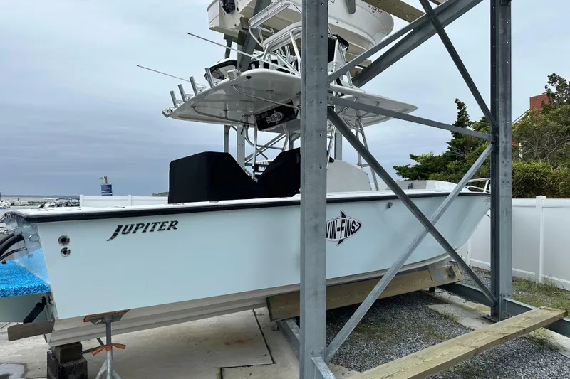 Slide: The Image of 1999 Jupiter 31 Cuddy boat on lift, showcasing sleek design and sturdy construction. - 45