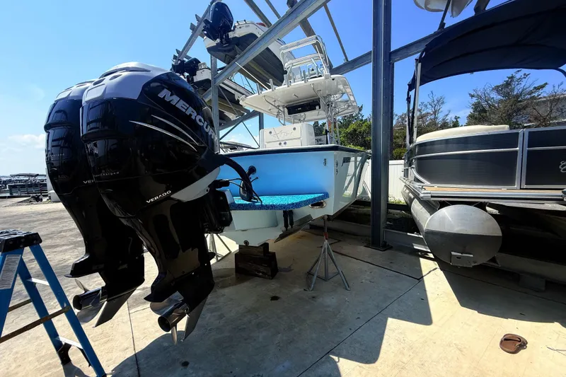 Slide: The Image of 1999 Jupiter 31 Cuddy boat with dual Mercury Verado engines in a marina setting. - 5