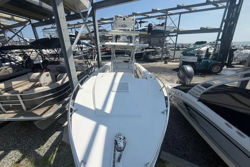 Slide: The Image of 1999 Jupiter 31 Cuddy boat in storage, surrounded by other vessels. - 8