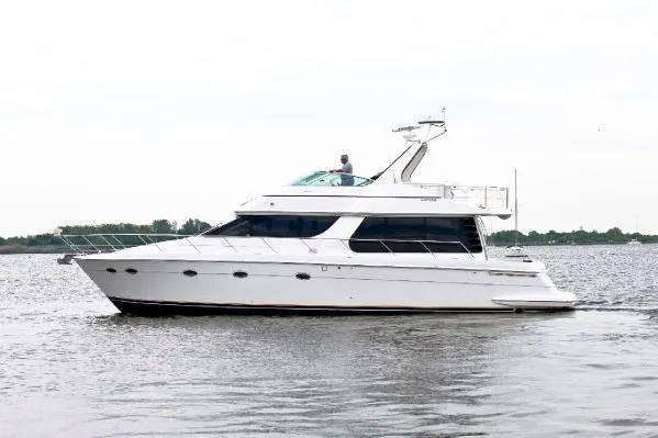 The Image of 2001 Carver 530 Voyager Pilothouse yacht cruising on calm waters. - 1