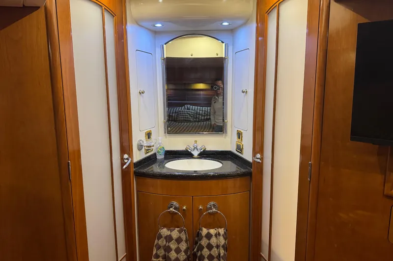 Slide: The Image of Luxurious bathroom in 2001 Carver 530 Voyager Pilothouse yacht with wood accents and modern fixtures. - 32