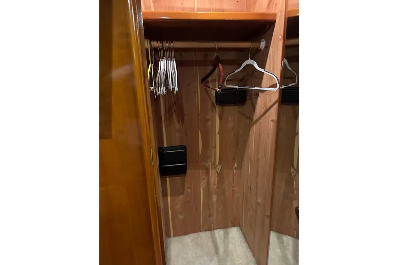 Slide: The Image of Wooden closet interior with hangers, inside a 2001 Carver 530 Voyager Pilothouse. - 35