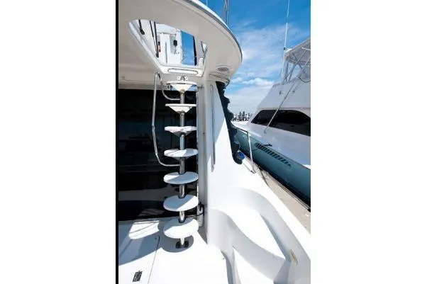 Slide: The Image of Staircase on 2001 Carver 530 Voyager Pilothouse yacht, docked under clear blue sky. - 4