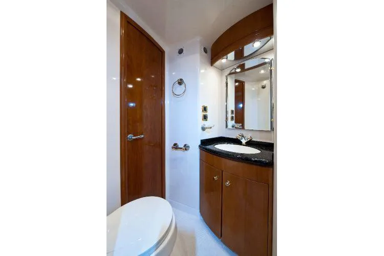 Slide: The Image of Luxurious bathroom in 2001 Carver 530 Voyager Pilothouse yacht with wood accents and modern fixtures. - 11