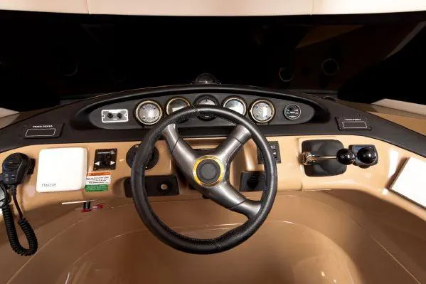 Slide: The Image of Pilothouse interior of 2001 Carver 530 Voyager, featuring steering wheel and control panel. - 19