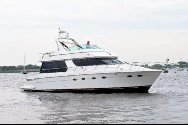 Slide: The Image of 2001 Carver 530 Voyager Pilothouse yacht on calm water. - 3