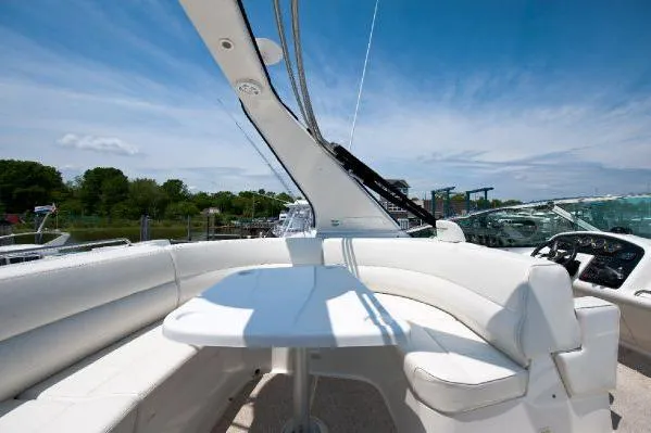 Slide: The Image of 2001 Carver 530 Voyager Pilothouse yacht with white seating and table under blue sky. - 7