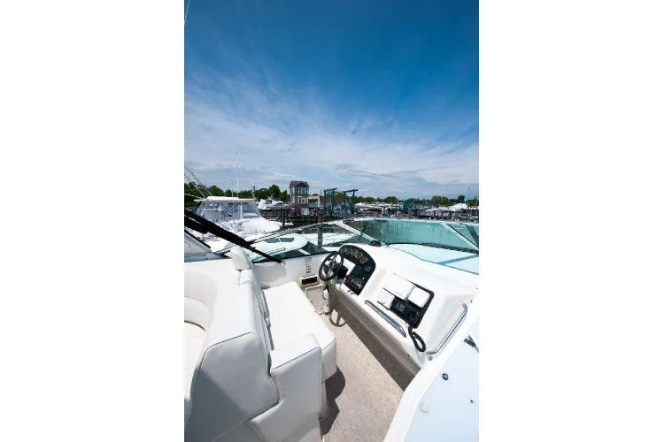 Slide: The Image of 2001 Carver 530 Voyager Pilothouse yacht interior with steering wheel and dashboard, docked at marina. - 8