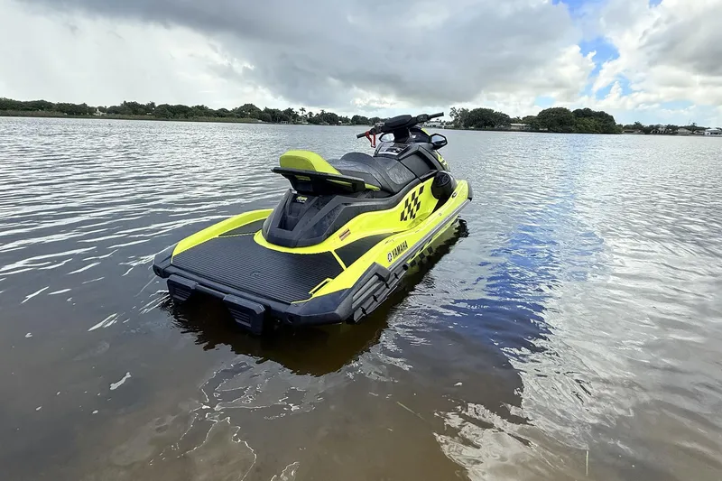 Slide: The Image of 2023 Yamaha WaveRunner VX110 jet ski on calm water under cloudy sky. - 11