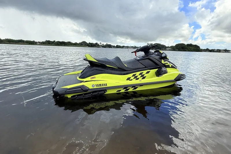 Slide: The Image of 2023 Yamaha WaveRunner VX110 jet ski on calm water, vibrant yellow design. - 12