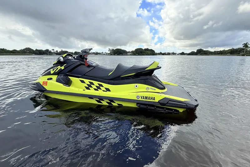 Slide: The Image of 2023 Yamaha WaveRunner VX110 jet ski on calm water, vibrant yellow and black design. - 14