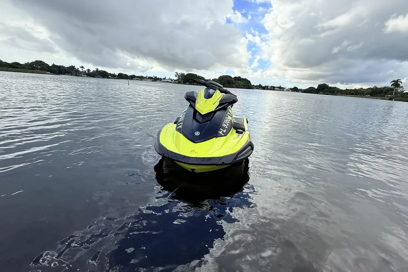 Slide: The Image of 2023 Yamaha WaveRunner VX110 jet ski on calm water under cloudy sky. - 15