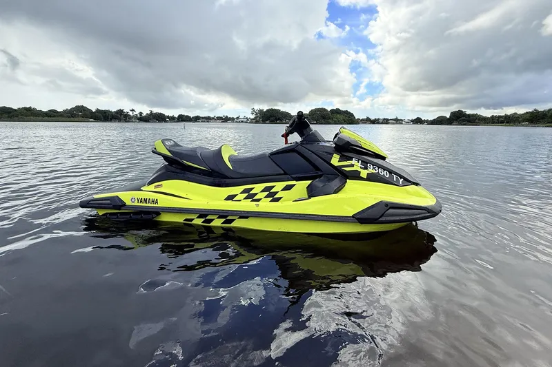 Slide: The Image of 2023 Yamaha WaveRunner VX110 jet ski on calm water, vibrant yellow design. - 17