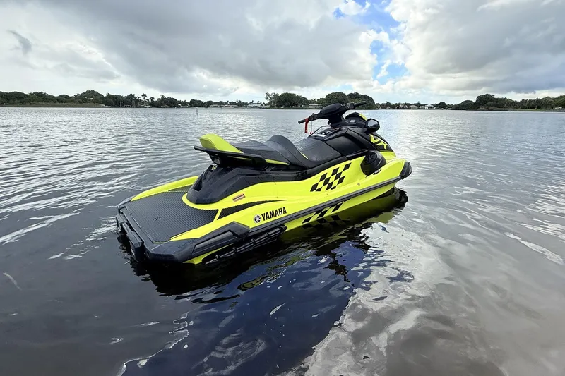 Slide: The Image of 2023 Yamaha WaveRunner VX110 jet ski on calm water, vibrant yellow design. - 18