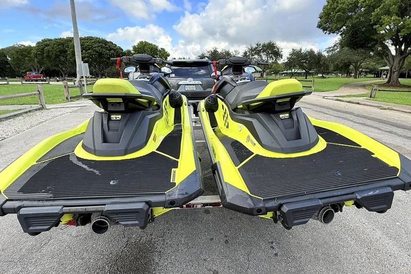 Slide: The Image of 2023 Yamaha WaveRunner VX110 jet skis on a trailer, parked outdoors. - 3