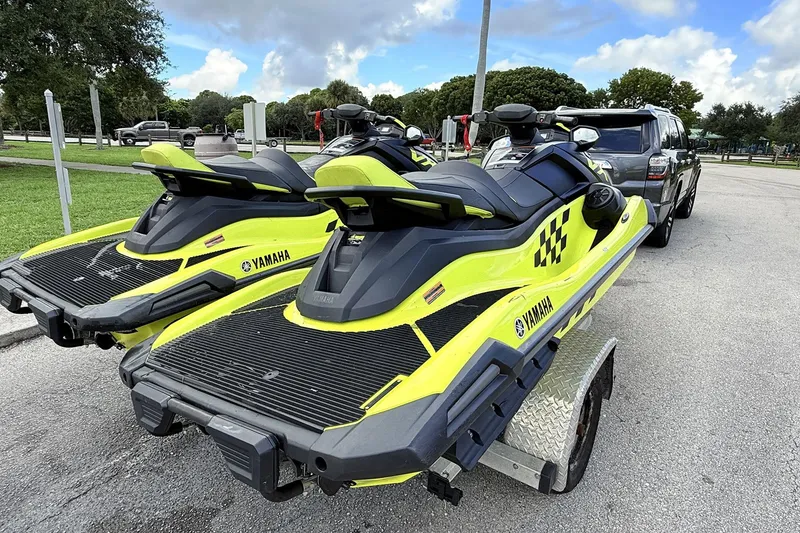Slide: The Image of 2023 Yamaha WaveRunner VX110 jet skis on trailer, vibrant yellow and black design. - 4