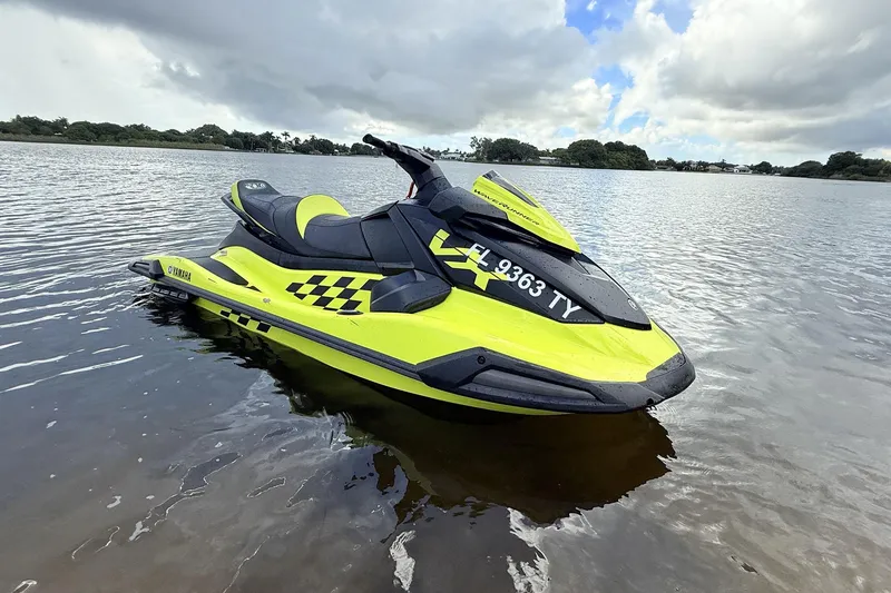 Slide: The Image of 2023 Yamaha WaveRunner VX110 jet ski on calm water, vibrant yellow design. - 5