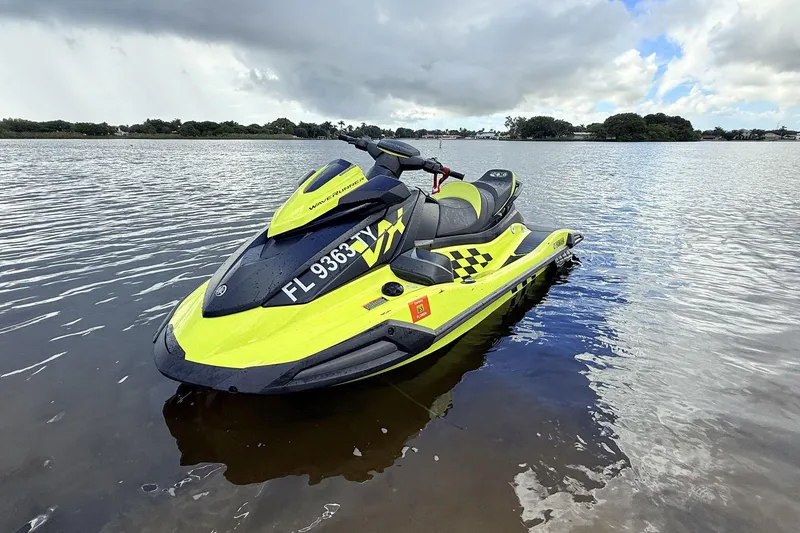 Slide: The Image of 2023 Yamaha WaveRunner VX110 jet ski on calm water under cloudy sky. - 7