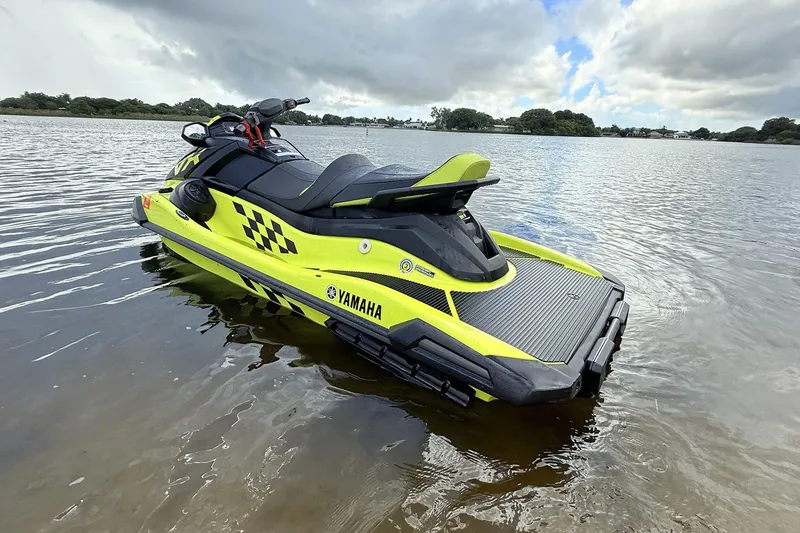 Slide: The Image of 2023 Yamaha WaveRunner VX110 in vibrant yellow on calm water. - 9