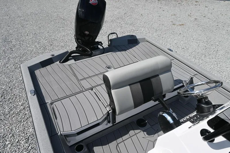 Slide: The Image of 2026 Vexus ACX 2000 boat interior with steering wheel and seating on gray deck. - 11