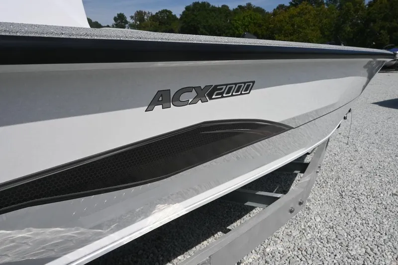 Slide: The Image of 2026 Vexus ACX 2000 boat side view on gravel surface. - 7
